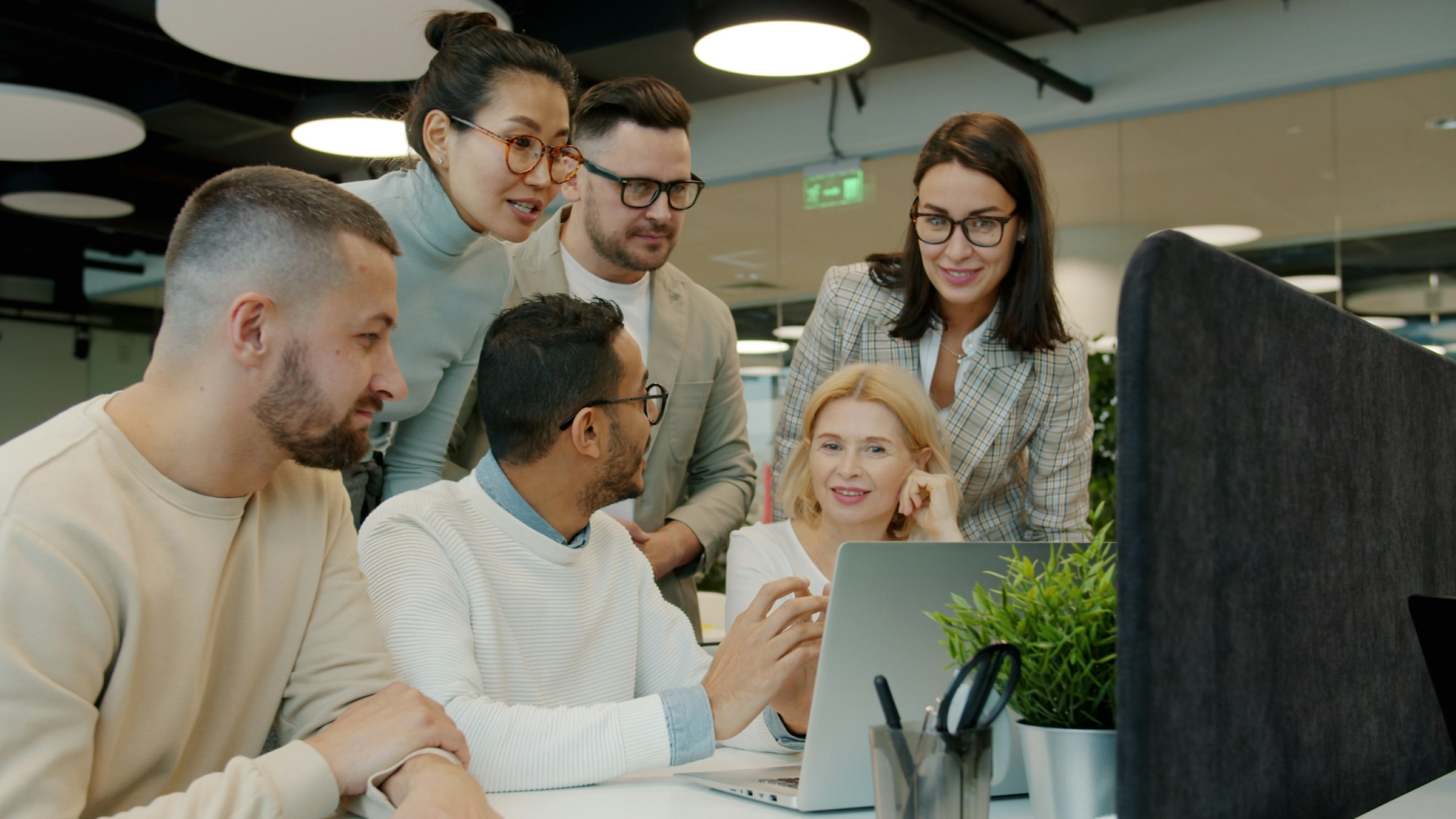 Diverse technology team collaborating and learning together in a modern workplace